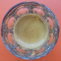An espresso in a glass, seen from directly above. The coffee is a single-origin Papua New Guinea bean, served in Jonestown Coffee, Bethnal Green Road.