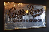 A mirror from the wall of Caffe Roma, New York City, with the slogan "Caffe Roma, Gelatic & Spumoni"