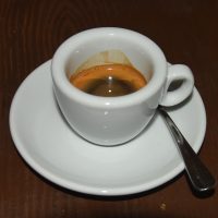 A washed Colombian espresso from Rebel Bean, served in a classic white cup at Coffee and Riot in Prague.