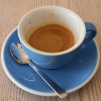 A double shot of espresso in a classic, oversized blue cup, served at Saucer & Cup.