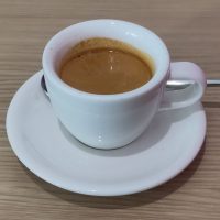 An espresso, served in a classic white cup