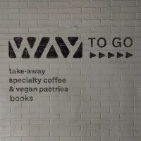 Details from the wall on the inside of the porch of the Way Coffee & Book Shop in Ghent"WAY to go, take-away speciality coffee & vegan pastries. Books"