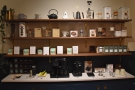 There are retail shelves, opposite the roaster, with the usual mix of coffee kit...