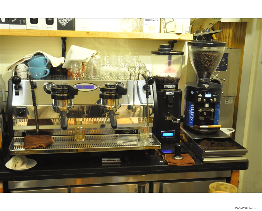 The epresso machine and its two grinders, seen here in 2016, are behind the coounter.