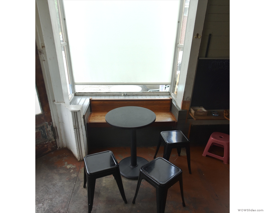 Each of the bay windows has its own table, stools and bench inset in the window.