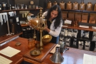 After all this, I had to have some coffee. This is Preethi, the manager, weighing out some...