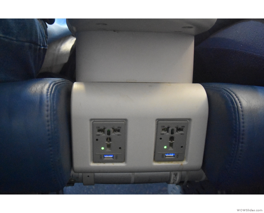 There's more power, a full international plug and another USB outlet, between the seats.