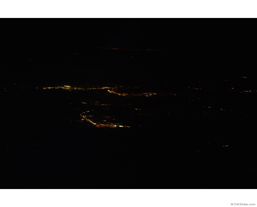 The clouds had cleared and I could see the lights of various towns below us.