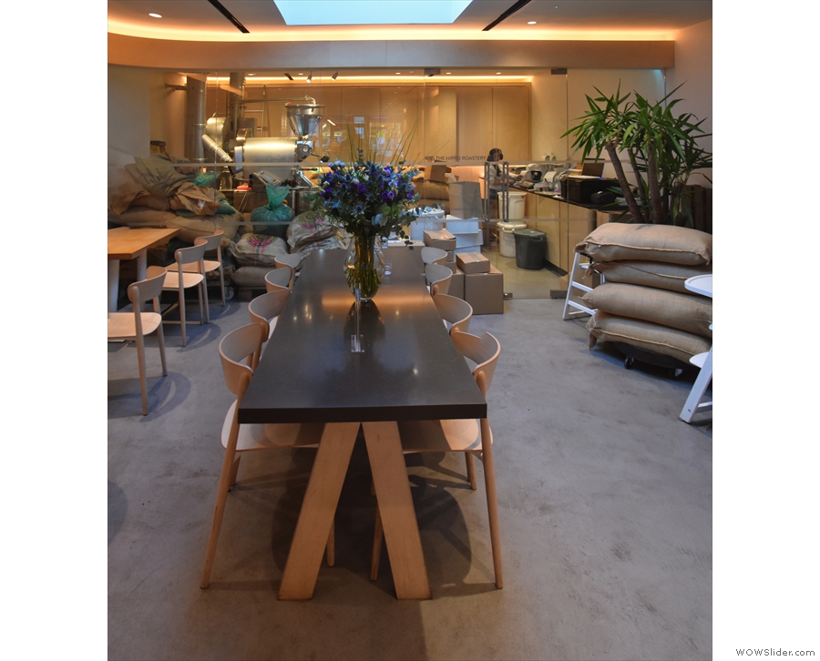 There's a large, eight-person communal table in the centre, under a skylight...
