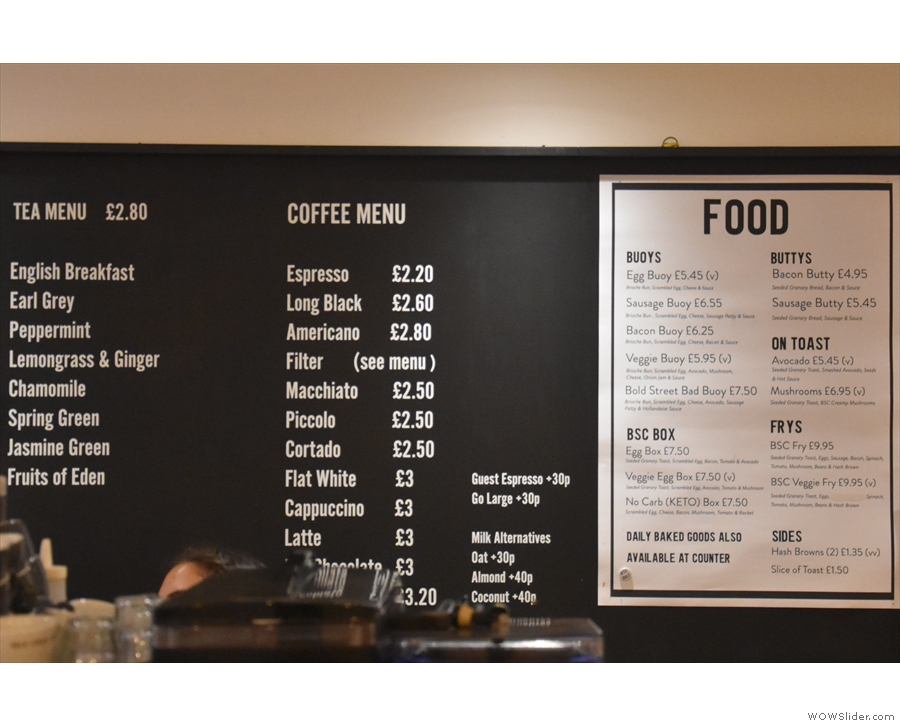 The tea, coffee and food menus are displayed on the wall behind the counter...