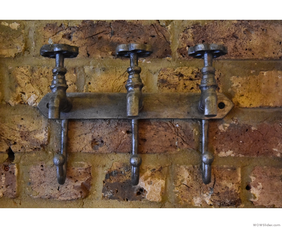 ... these old taps, which have been repurposed as coat hooks.