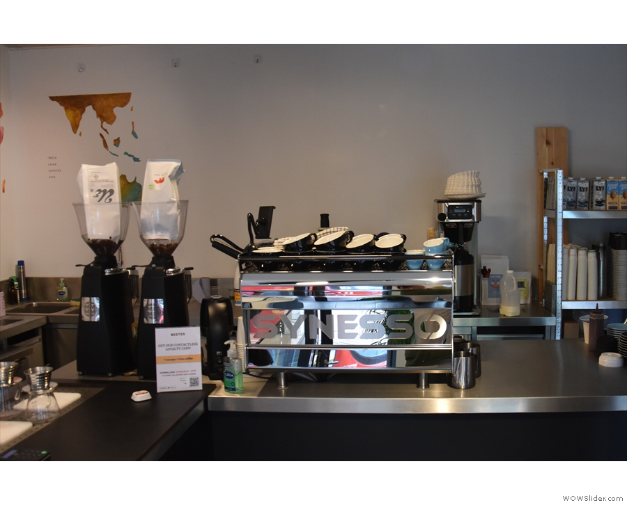 The Synesso espresso machine and its grinders are at the back of the counter.