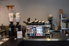 The Synesso espresso machine and its grinders are at the back of the counter.