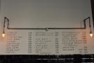 The menu, with the food on the right-hand side, is written on the wall behind the counter.