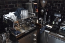 The espresso machine is at the other end of the counter, along with the grinders.