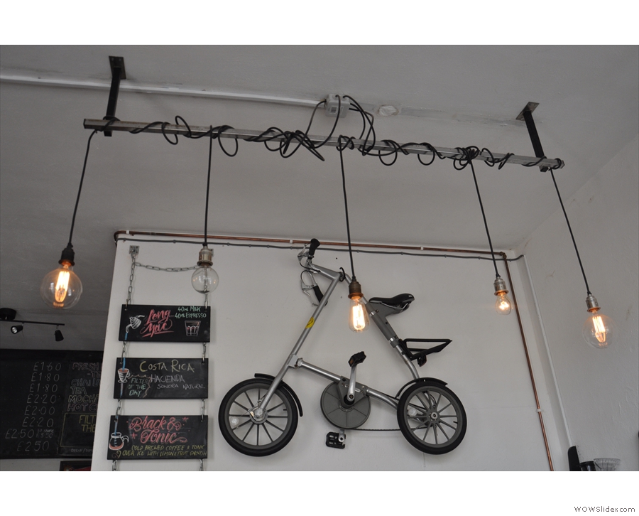 Naturally, there's a folding bike hanging on the wall behind the counter...
